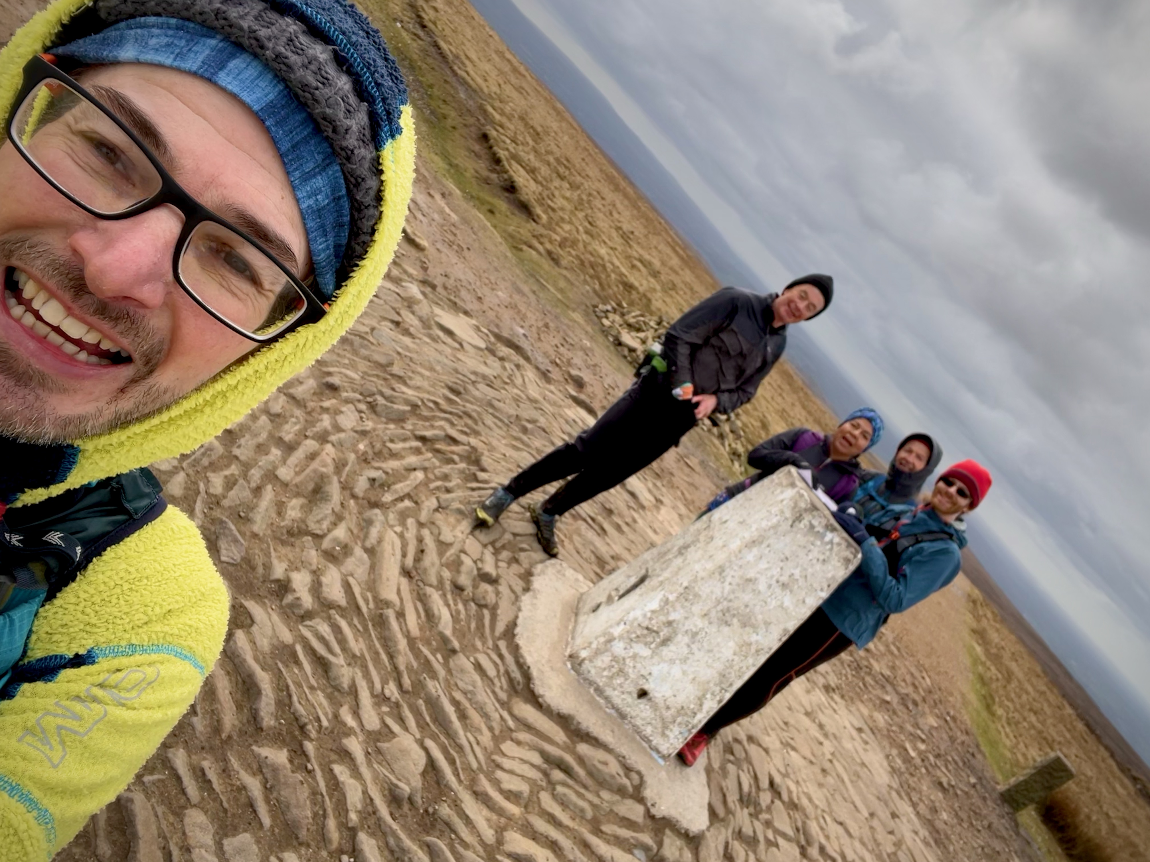 Selfie with runners gathered around Pendle Hill trig.