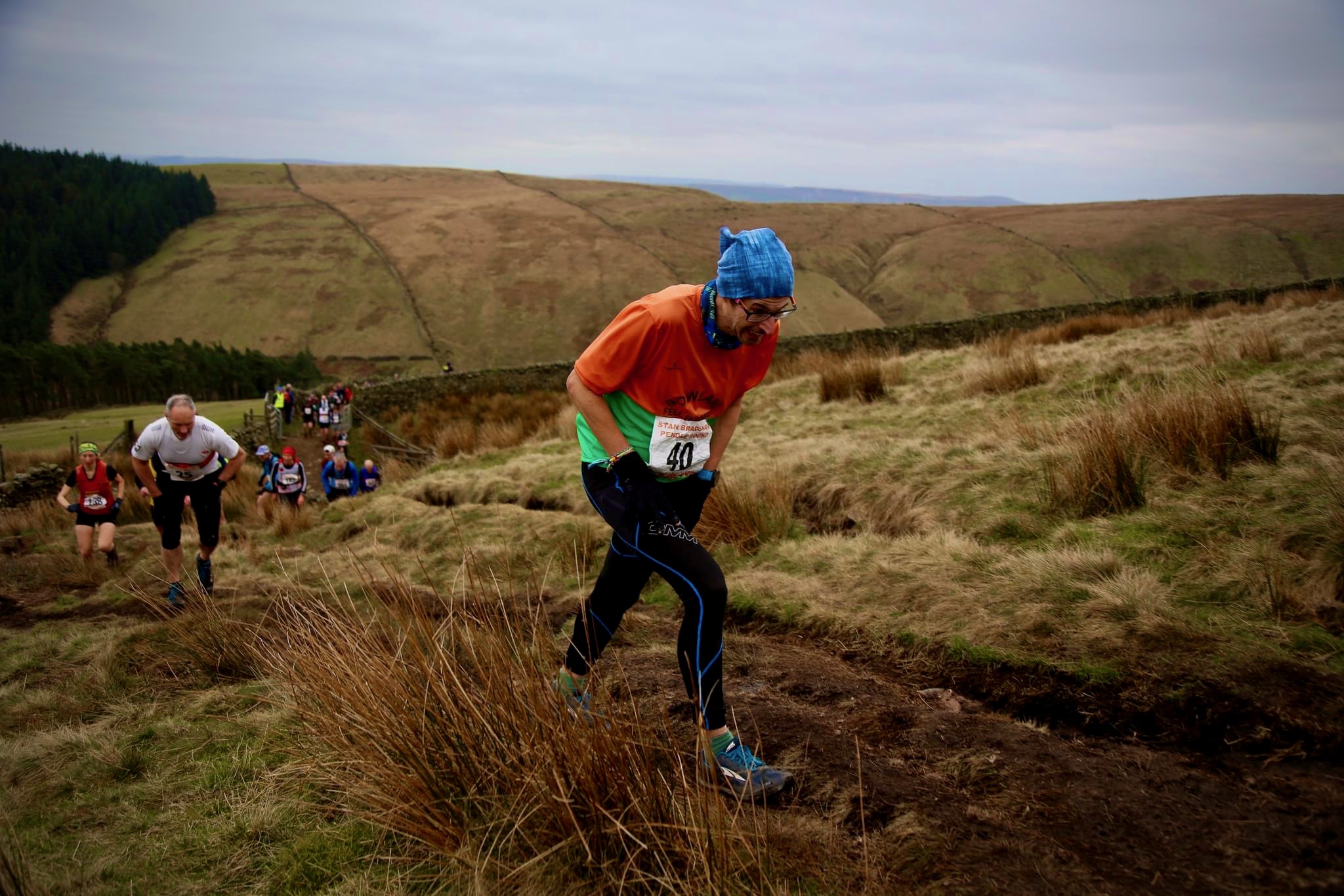 Hands on knees, climbing up Pendle Hill.