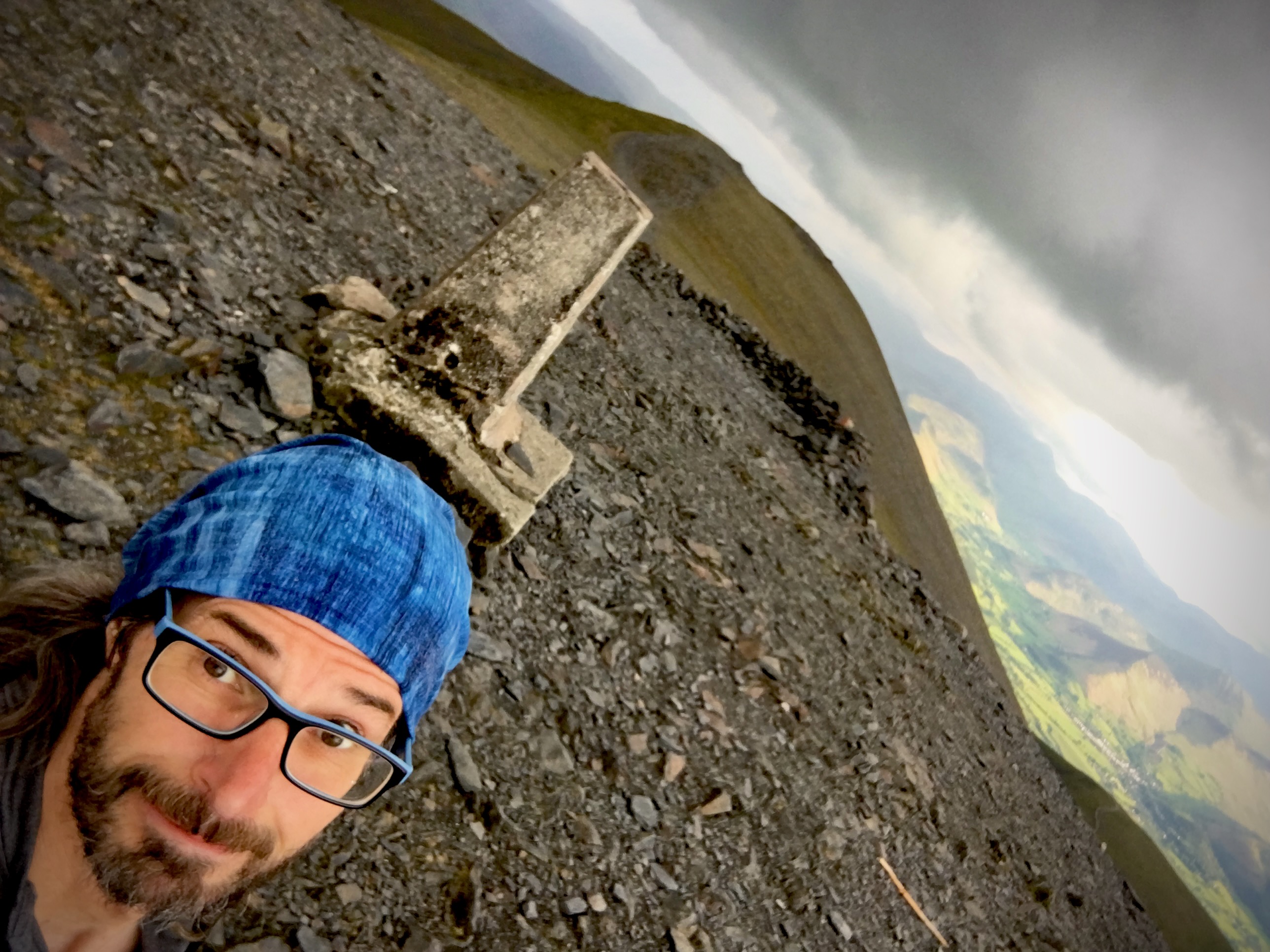 Headshot of Chris with Skiddaw trig in the background.