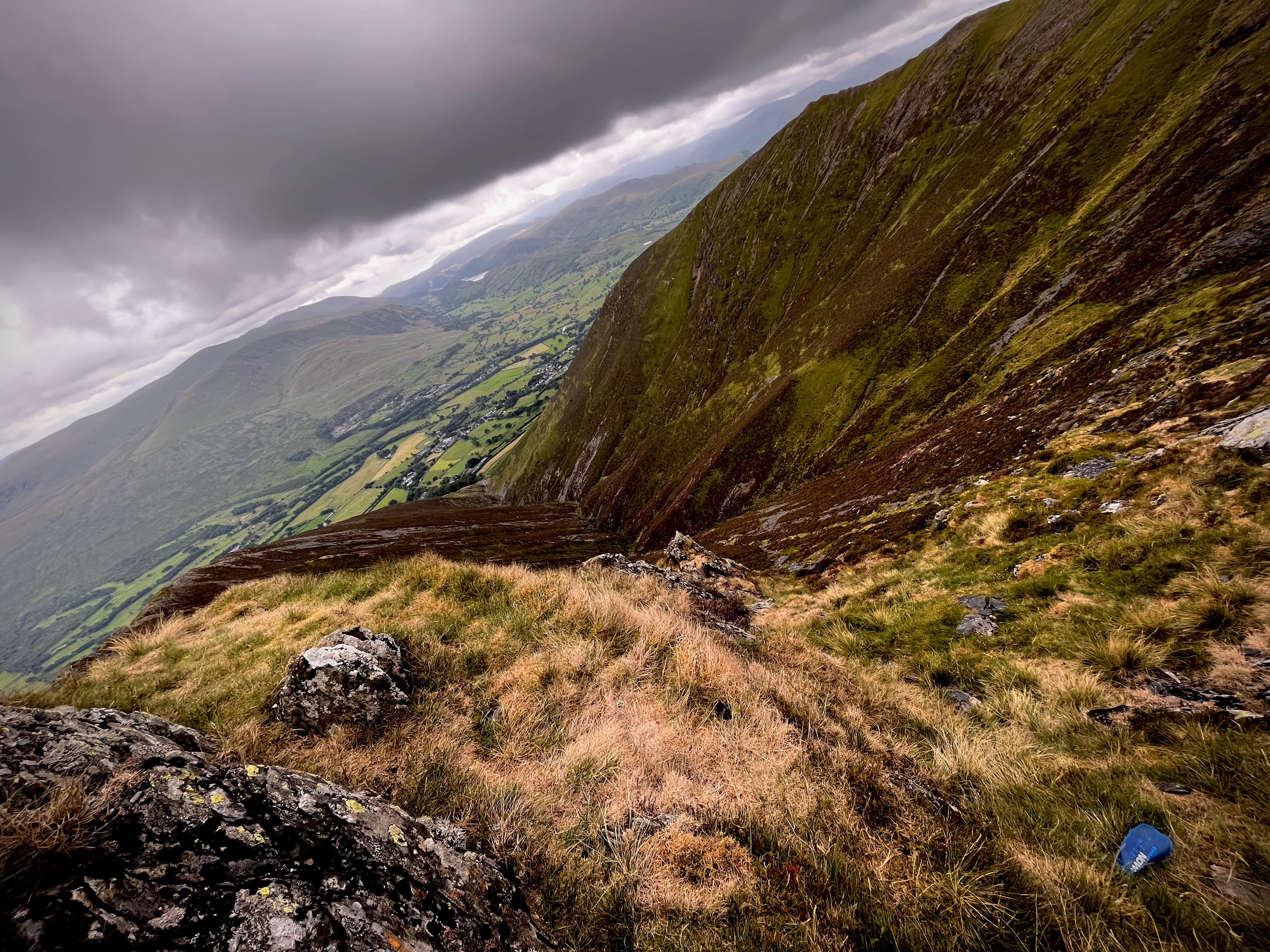 Soft flask laying in the grass below the summit of Blencathra.