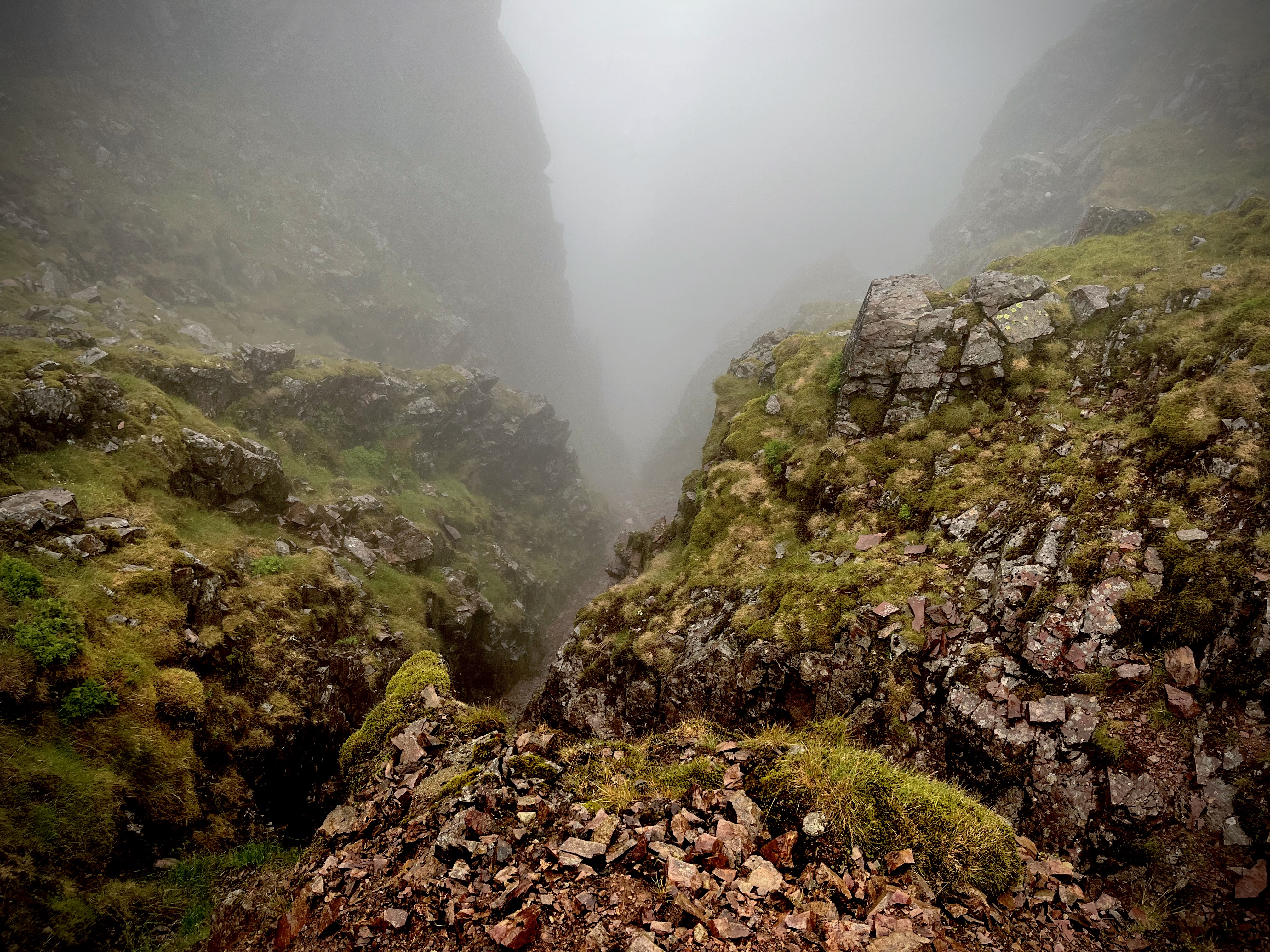 Steep gully in gloomy cloud, the top of the West Wall Traverse.